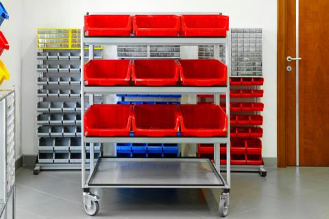 Red bins on a rolling shelving cart